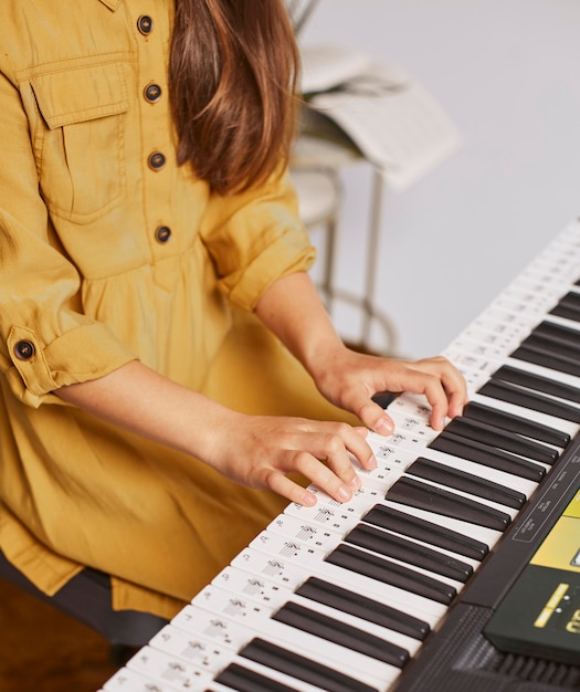 Young child learning how to play the electronic keyboard