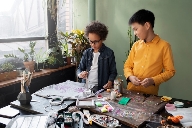 Free photo young child making diy project from upcycled materials