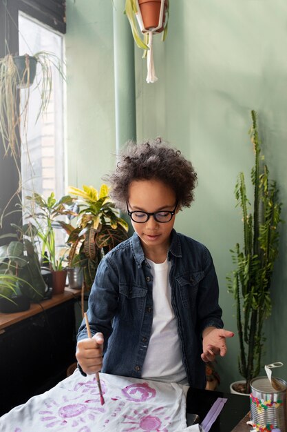 Young child making diy project from upcycled materials