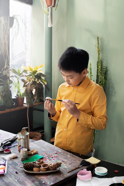 Young child making diy project from upcycled materials