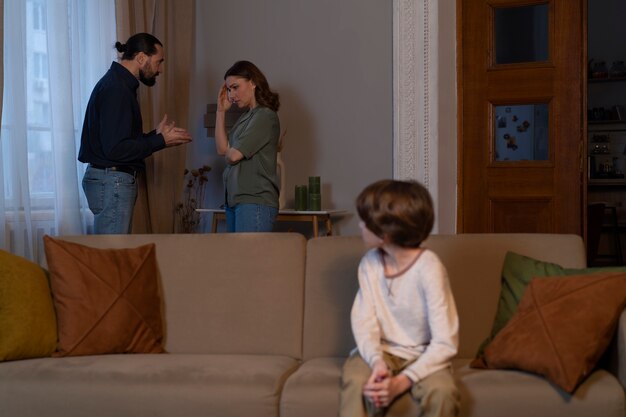 Young child suffering from abuse by parents fighting at home