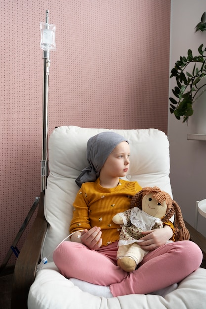 Free photo young child in therapy for battling cancer