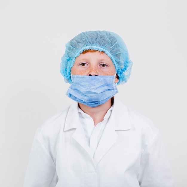 Young child with hair net and mask