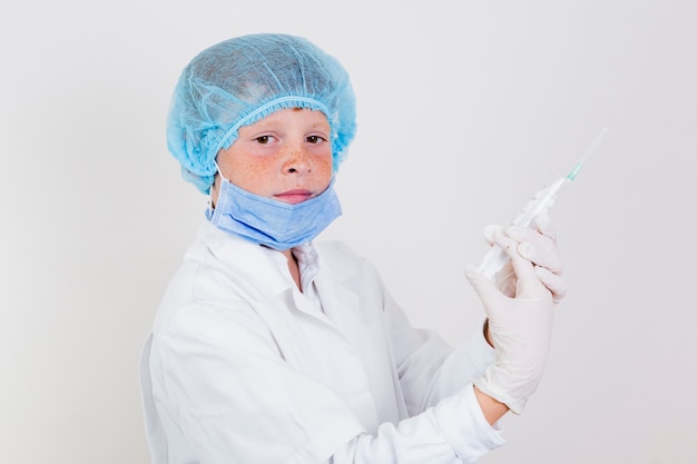 Young child with hair net and syringe