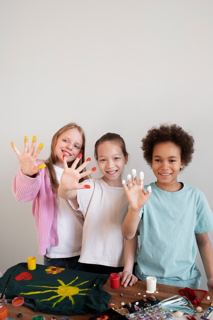 Young children with paint on fingers from diy upcycling project