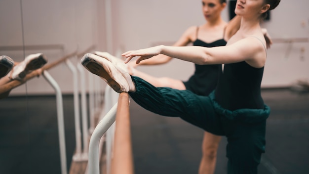 Young classic female dancers practising in the dance studio