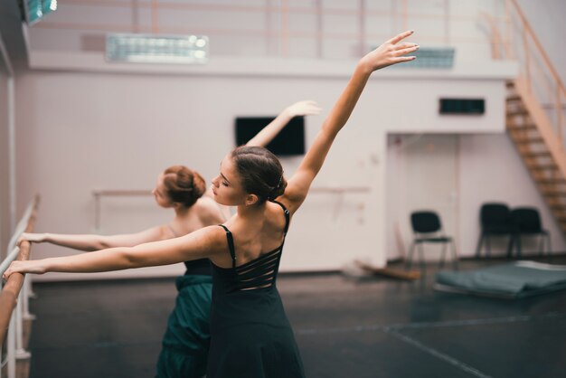 Young classic female dancers practising in the dance studio