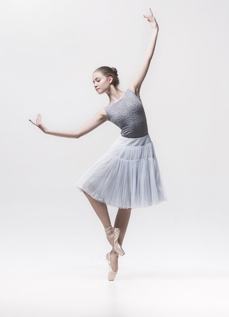 Young classical dancer isolated on white.