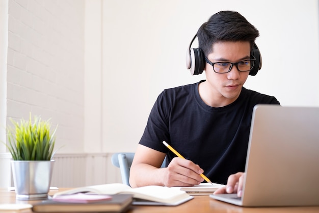 Young collage student using computer and mobile device studying online. education and online learning. Premium Photo