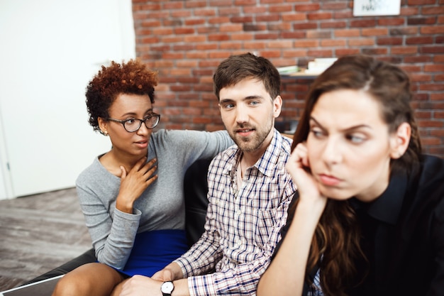 Young colleagues communicating during business brake at the office.