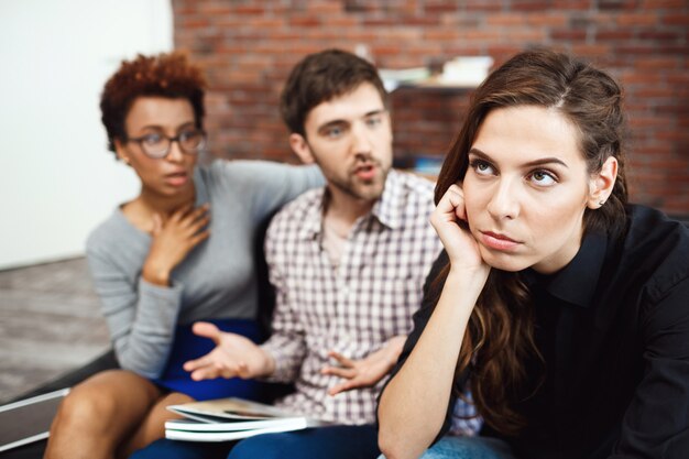 Young colleagues communicating during business brake at the office.