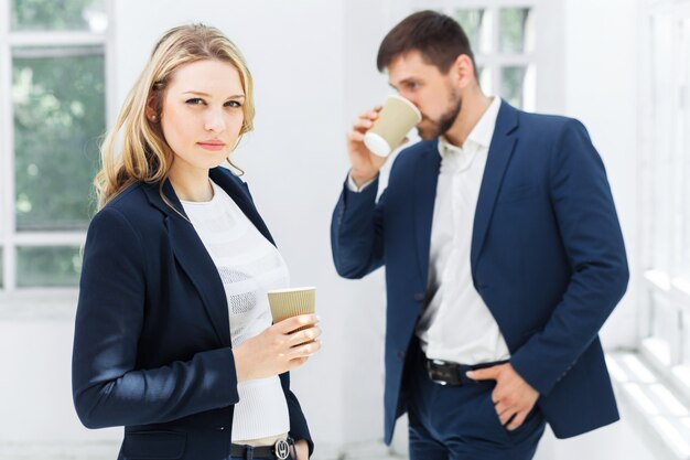 Young colleagues having coffee break in office