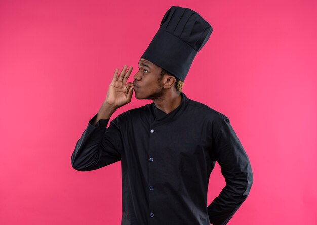 요리사 유니폼 제스처에 젊은 자신감 아프리카 계 미국인 요리사 맛있는 맛있는 복사 공간 분홍색 배경에 고립