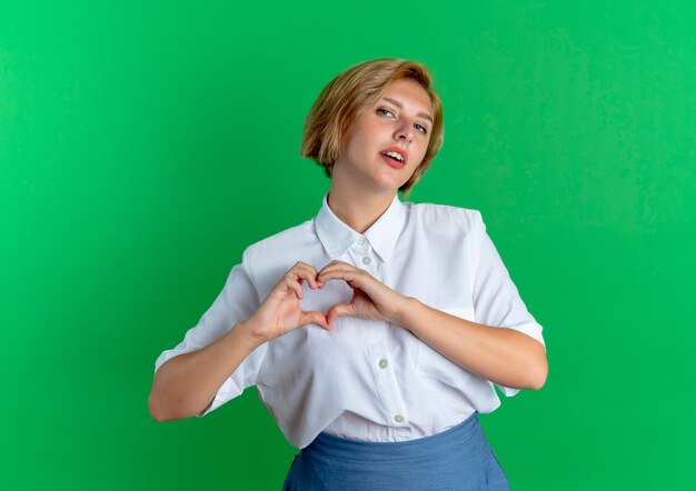 young confident blonde russian girl gestures heart hand sign