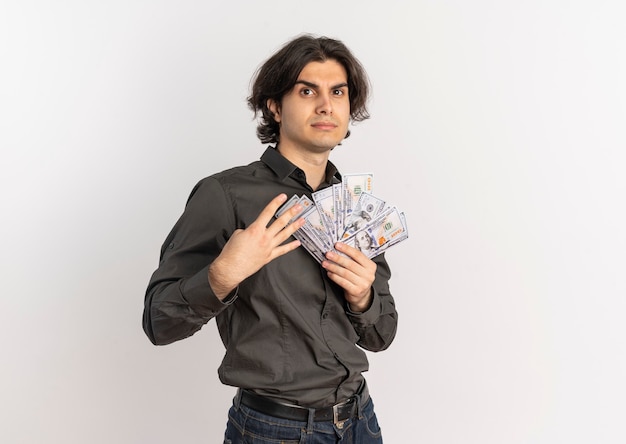 Free photo young confident handsome caucasian man holds money and gestures four with fingers isolated on white background with copy space