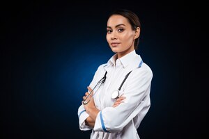 Free photo young confident lady doctor in medical gown looking