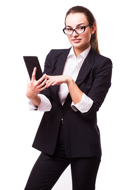 Young, confident, successful and beautiful business woman with the tablet computer isolated on white wall