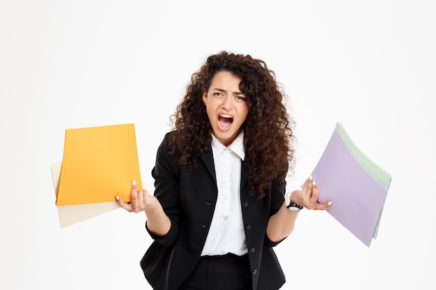 Young confused curly girl holding documents