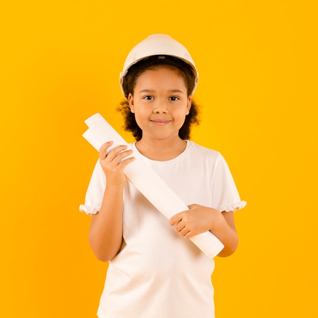 Young construction worker holding project