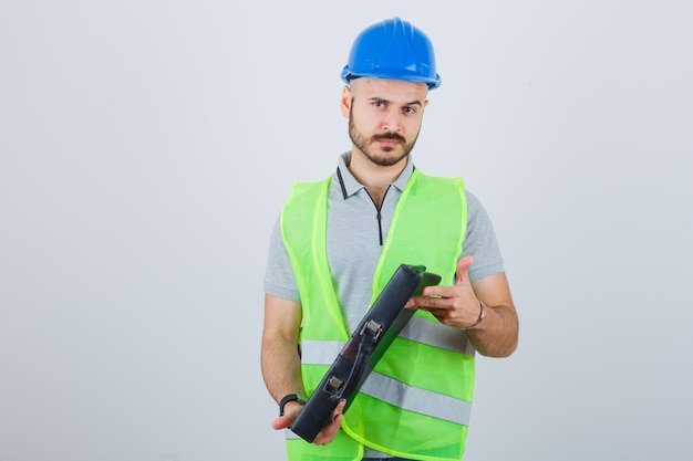 Young construction worker wearing a safety helmet