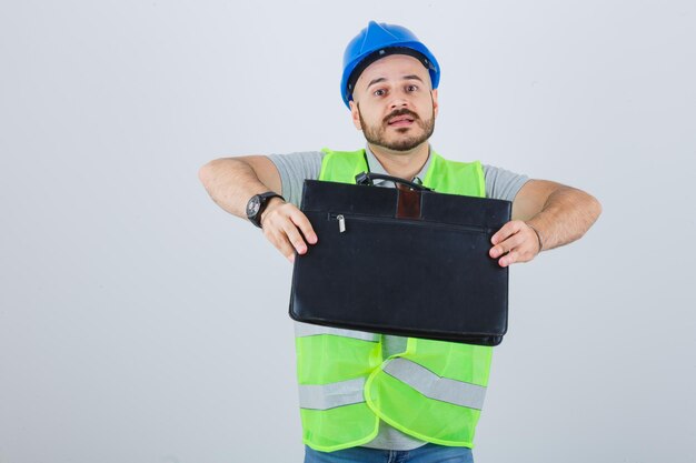 Young construction worker wearing a safety helmet