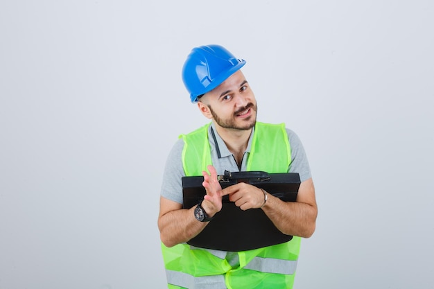 Young construction worker wearing a safety helmet