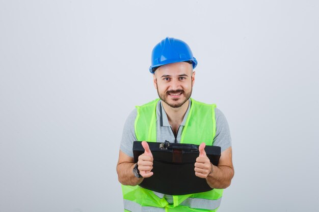 Young construction worker wearing a safety helmet