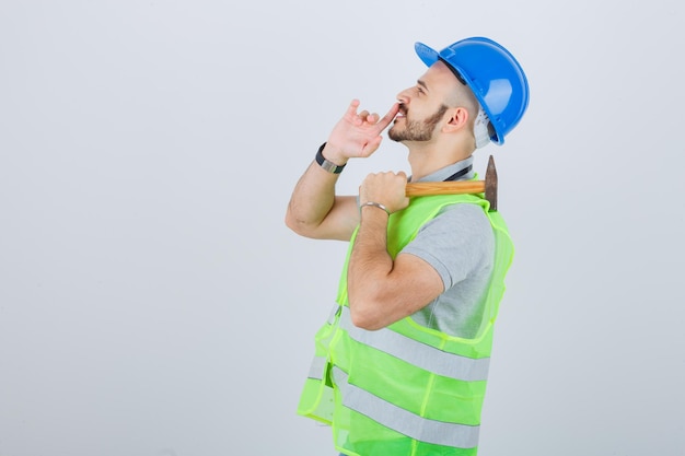 Young construction worker wearing a safety helmet