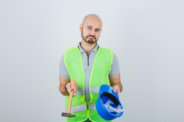 Free photo young construction worker wearing a safety helmet