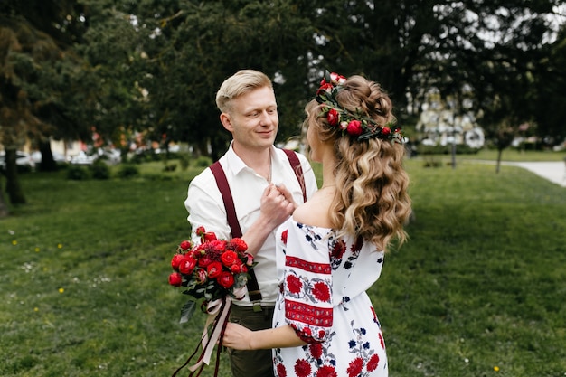 Free photo young  couple in a blooming garden