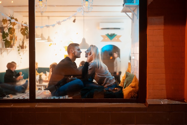 Young couple in cafe with stylish interior