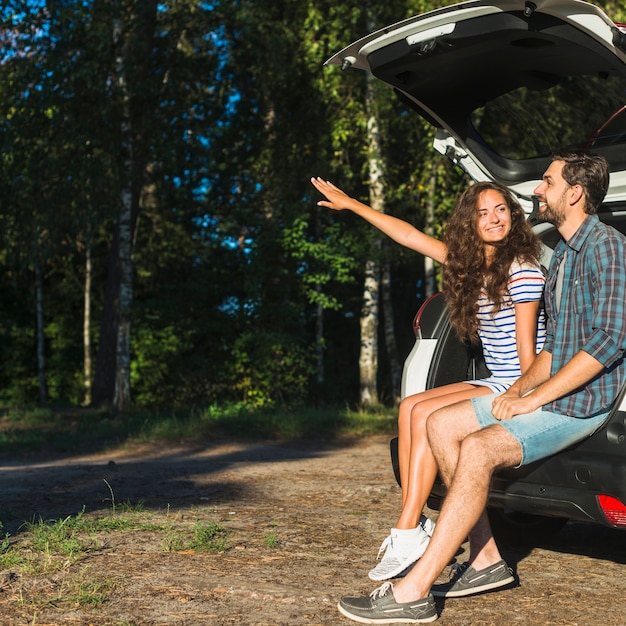 Free photo young couple on a car trip