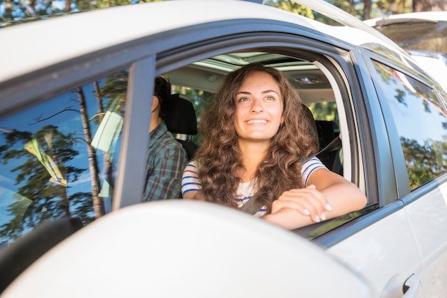 Free photo young couple on a car trip