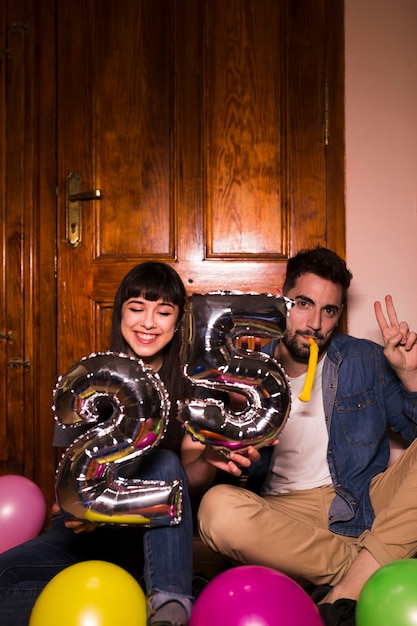 Young couple celebrating 25th birthday at home