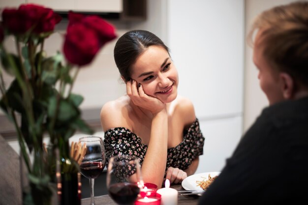 Young couple celebrating valentine's day while having lunch and wine together