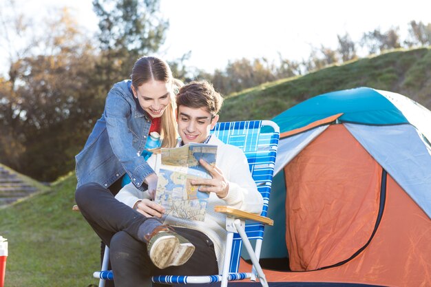 Young couple checking the map together