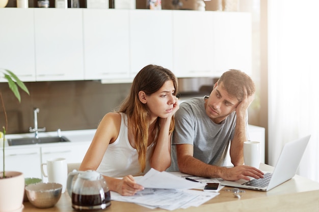 Young couple checking their family budget