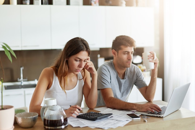 young couple checking their family budget