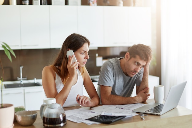 Young couple checking their family budget