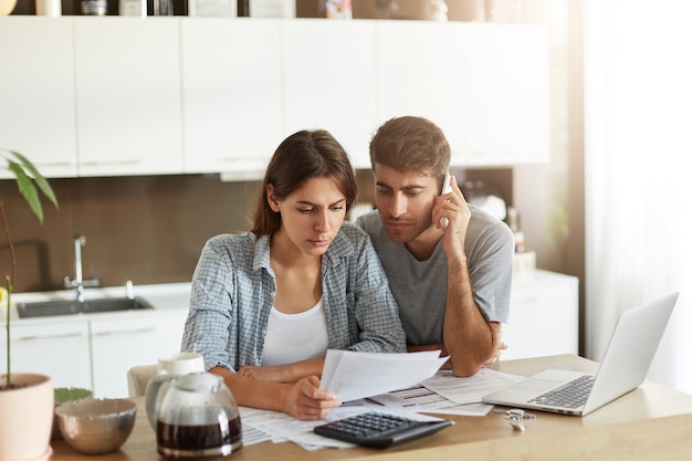 Young couple checking their family budget