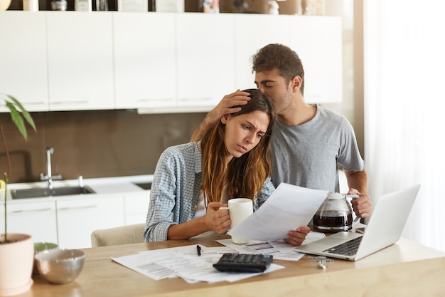 Young couple checking their family budget