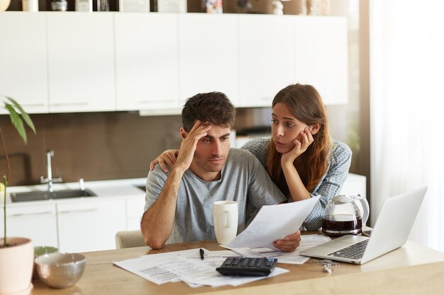 young couple checking their family budget