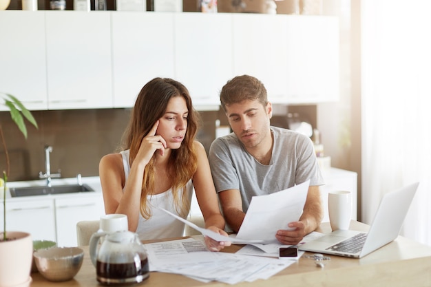 Young couple checking their family budget