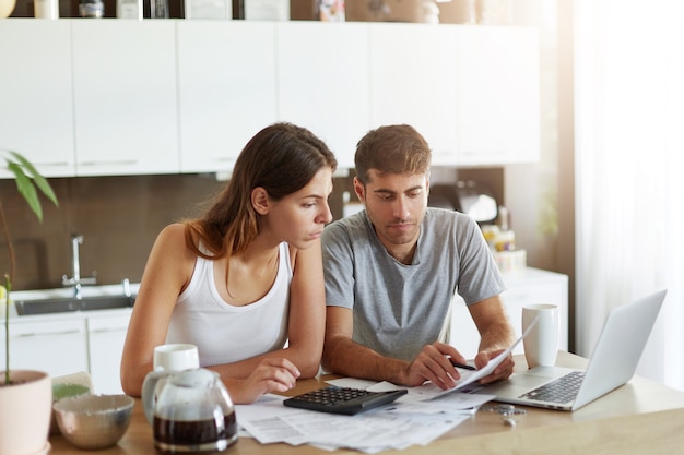 Young couple checking their family budget