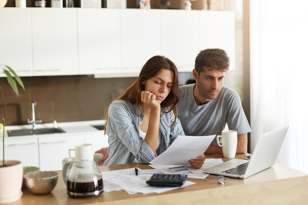Young couple checking their family budget