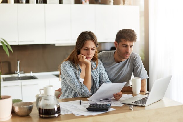 Young couple checking their family budget