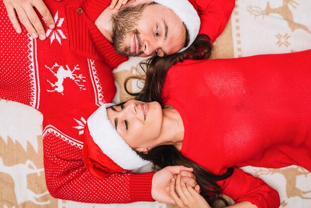 Young couple in Christmas hats