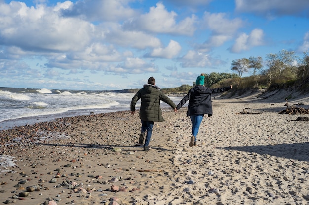 young couple of the cold Baltic sea