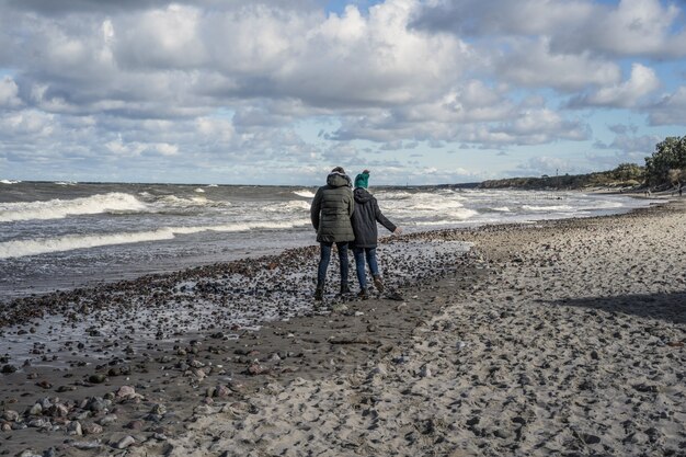 young couple of the cold Baltic sea