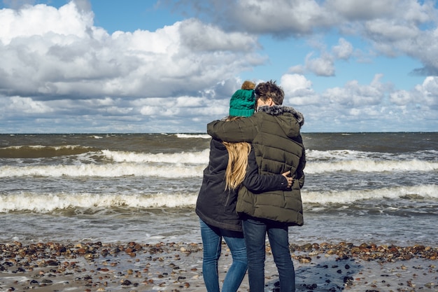 young couple of the cold Baltic sea
